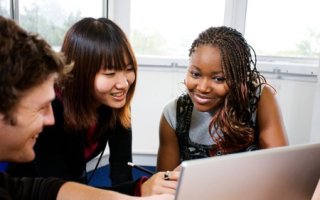 three youth at laptop